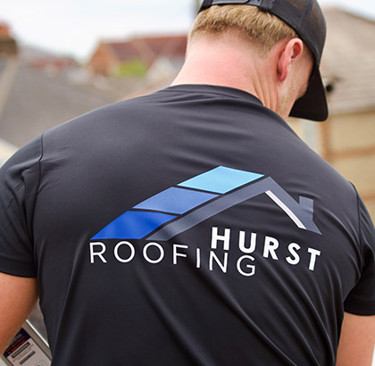 Hurst Roofing team working on a pitched roof in Dorset